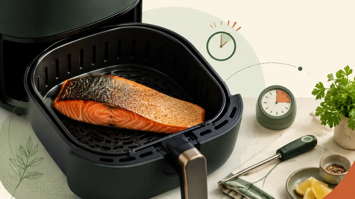 Salmon Fillet in an air fryer basket with a thermometer and timing cues for air fryer temperature and cooking time guidance.
